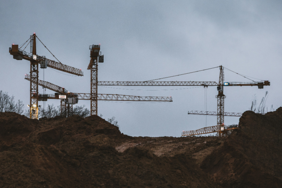 Tower cranes demonstrating structural engineering in construction sites.