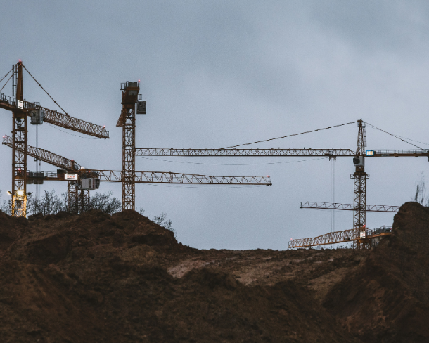 Tower cranes demonstrating structural engineering in construction sites.