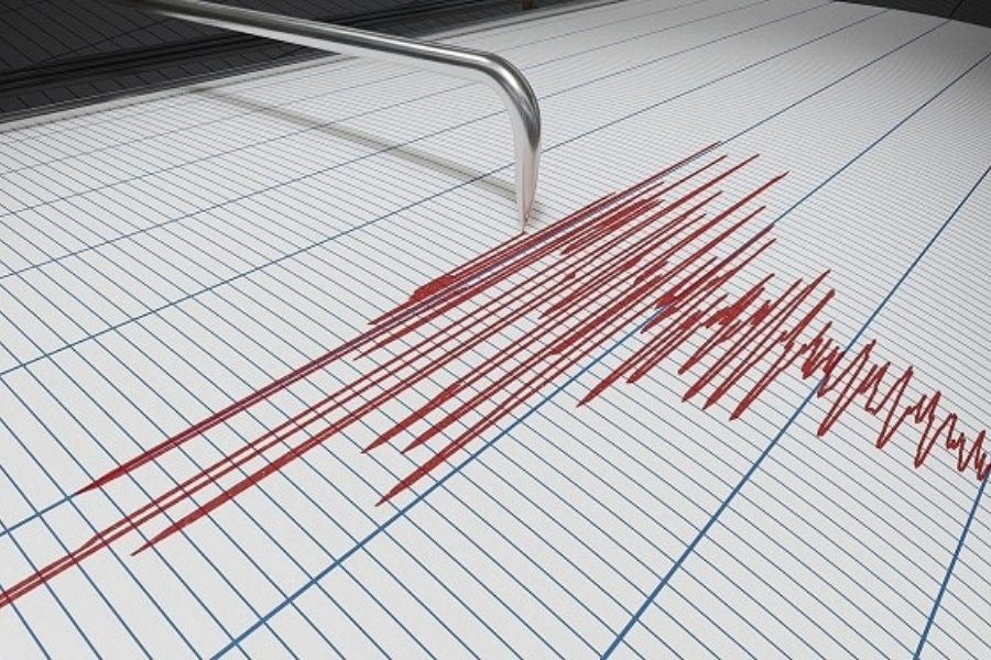 Seismograph recording earthquake magnitude on graph paper.