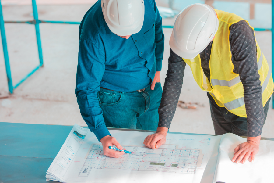 Structure Assessment: Designed for One Condition, Lifted in Another Yenem Structural Engineers Construction workers doing structure assessment review for building plans.