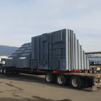 Transport Engineering: The Hidden Loads No One Talks About Yenem Structural Engineers Oversized load: a large, gray industrial component on a flatbed truck for transport engineering.