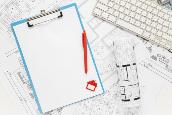 Why Your 80-Page Inspection Report Still Doesn’t Tell You What to Fix Yenem Structural Engineers Blueprint plans inspection report with clipboard, pen, house model, and keyboard; architectural design concept.